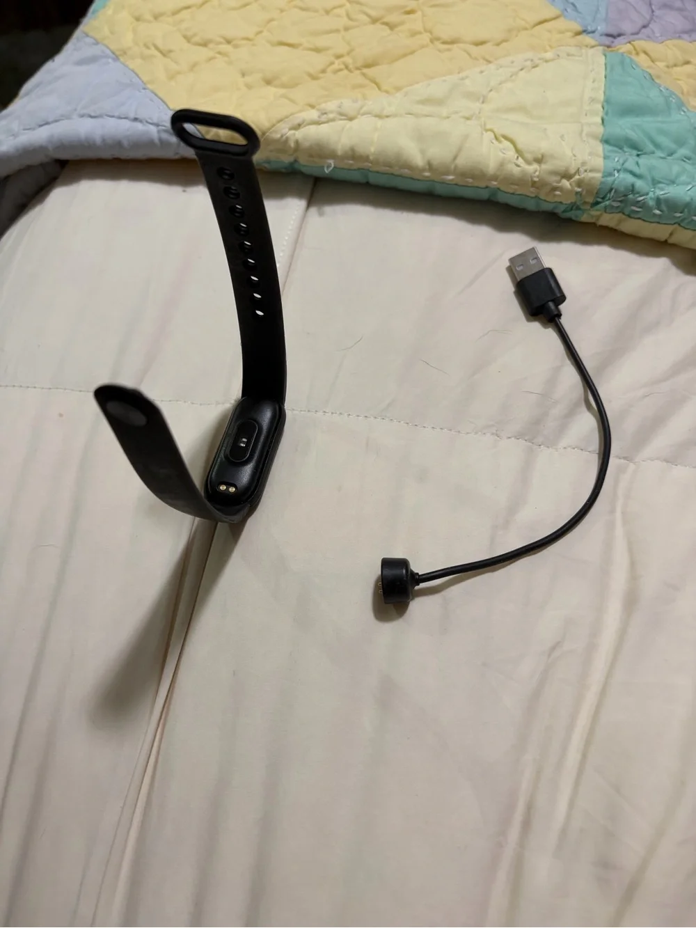 black Xiaomi Mi Band fitness tracker, model 6 or similar,